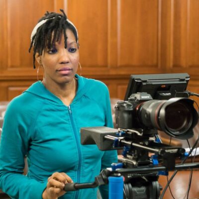 Film director Brandi Webb behind the camera filming her documentary Betrayal of a Nation